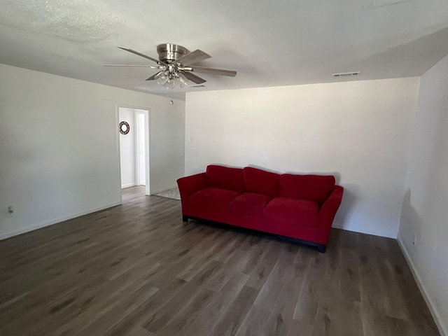sitting room with visible vents, wood finished floors, baseboards, and ceiling fan