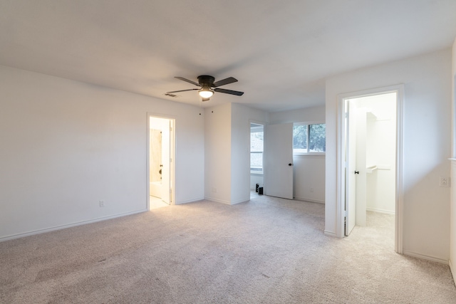 empty room with light carpet, visible vents, baseboards, and a ceiling fan