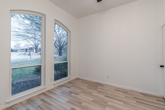 spare room with light wood-style flooring and baseboards