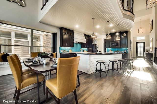 1231 Streamside Dr, Prosper, TX 75078 - dining room featuring a towering ceiling, dark wood-type flooring, and recessed lighting