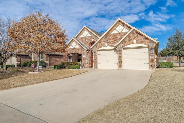 view of front of property with concrete driveway, brick siding, and an attached garage