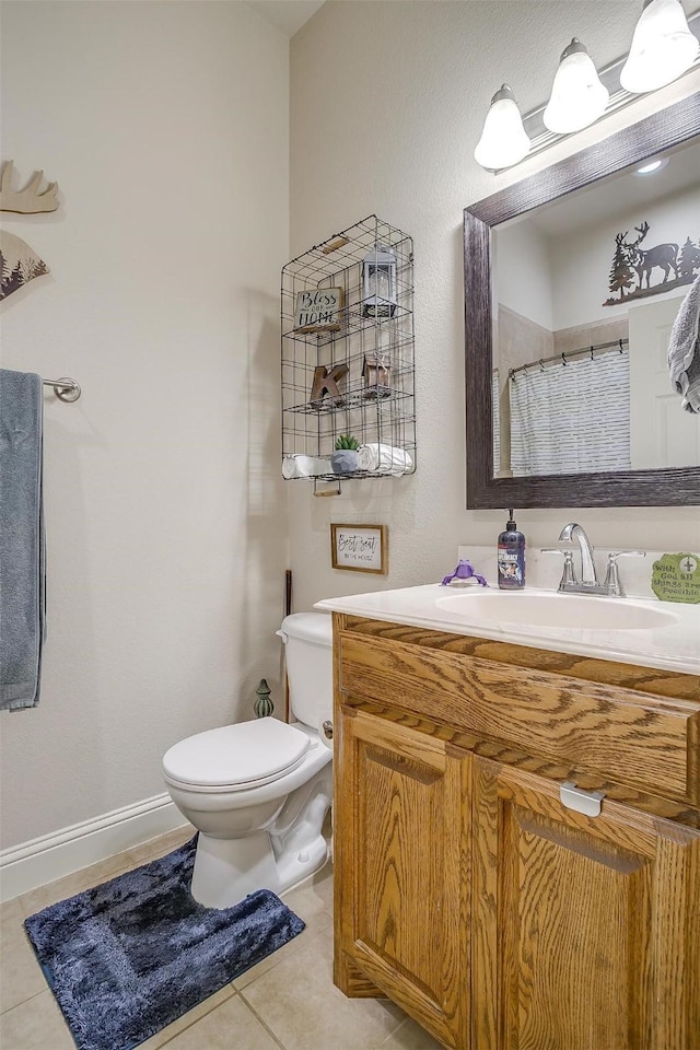 bathroom with baseboards, toilet, a shower with curtain, tile patterned floors, and vanity