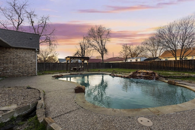 pool at dusk with a fenced in pool, a fenced backyard, and a patio