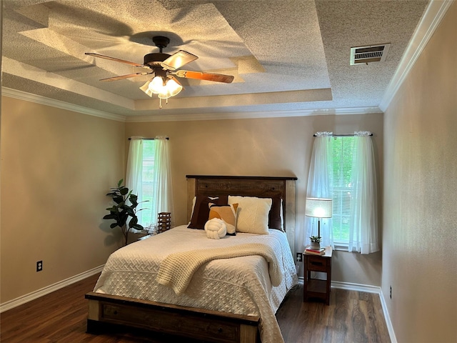 122 Lakeway Ln, Gun Barrel City, TX 75156 - bedroom with wood finished floors, a raised ceiling, a textured ceiling, baseboards, and ornamental molding