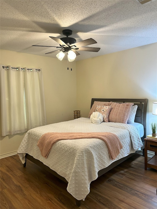 122 Lakeway Ln, Gun Barrel City, TX 75156 - bedroom featuring wood finished floors, a ceiling fan, a textured ceiling, and baseboards