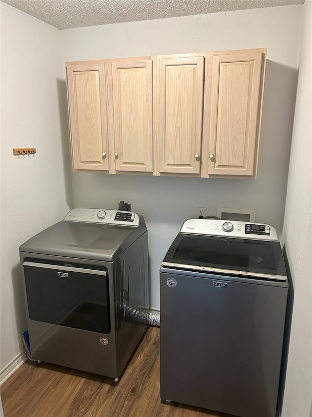 122 Lakeway Ln, Gun Barrel City, TX 75156 - washroom featuring cabinet space, separate washer and dryer, dark wood finished floors, and a textured ceiling