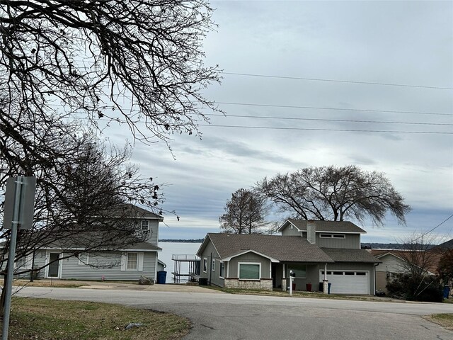 122 Lakeway Ln, Gun Barrel City, TX 75156 - view of front of house featuring driveway, roof with shingles, and a garage