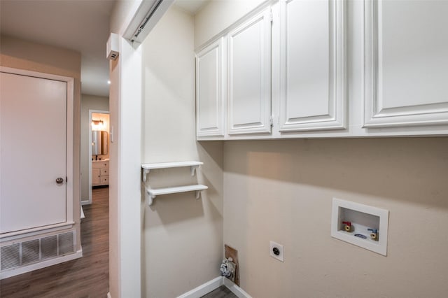 laundry room featuring dark wood-style flooring, hookup for a washing machine, cabinet space, visible vents, and hookup for an electric dryer