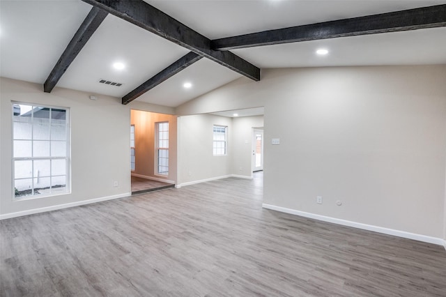 spare room featuring lofted ceiling with beams, recessed lighting, wood finished floors, visible vents, and baseboards