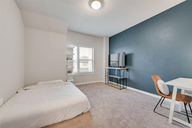 carpeted bedroom featuring baseboards