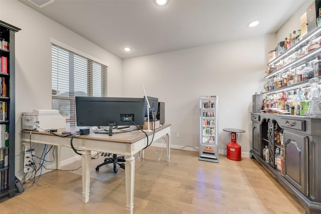 office area with baseboards, light wood finished floors, and recessed lighting