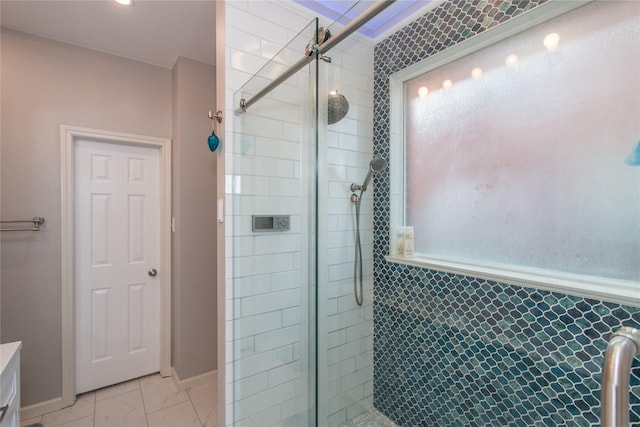 full bath featuring marble finish floor, a shower stall, and baseboards