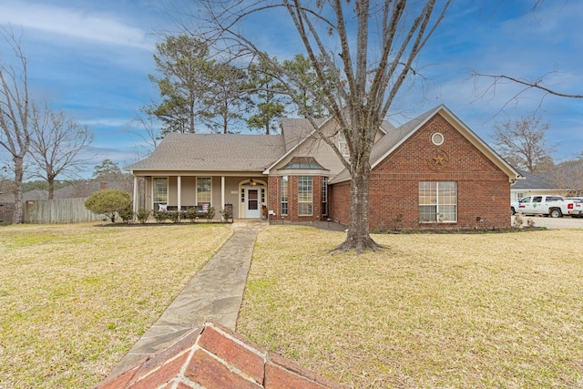 view of front of home featuring a porch, a front yard, and brick siding