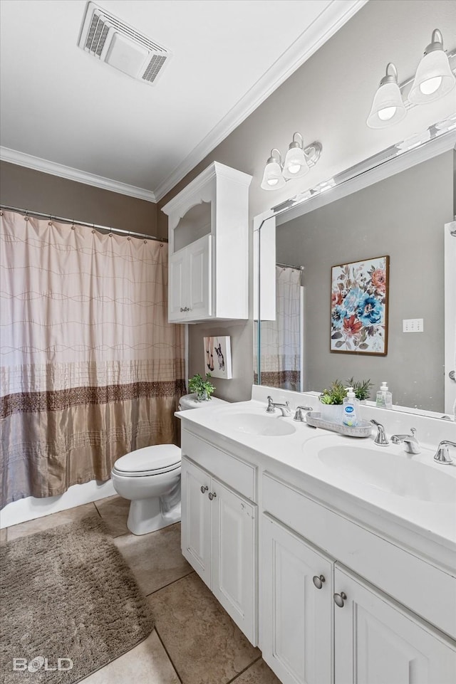 bathroom featuring ornamental molding, visible vents, and a sink