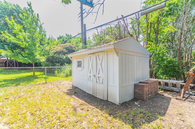 view of shed featuring fence