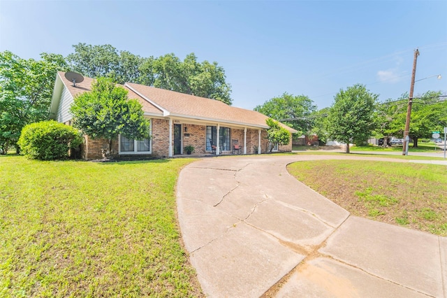 single story home featuring a front yard, concrete driveway, and brick siding