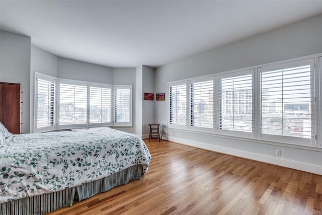 bedroom with baseboards and wood finished floors