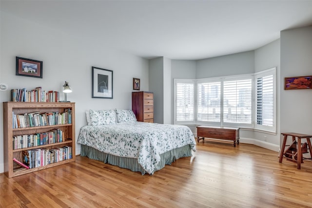 bedroom featuring baseboards and wood finished floors