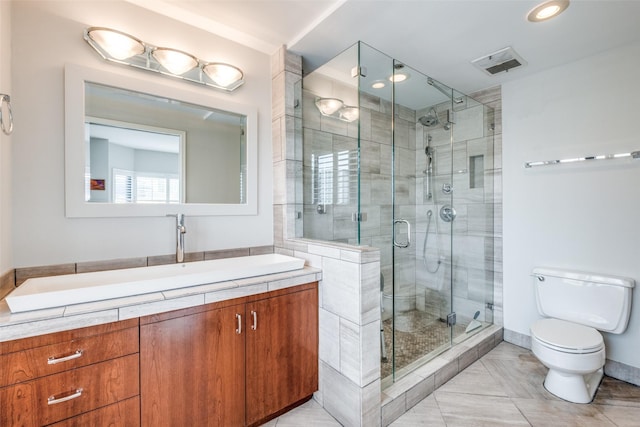 bathroom with visible vents, toilet, vanity, a shower stall, and recessed lighting