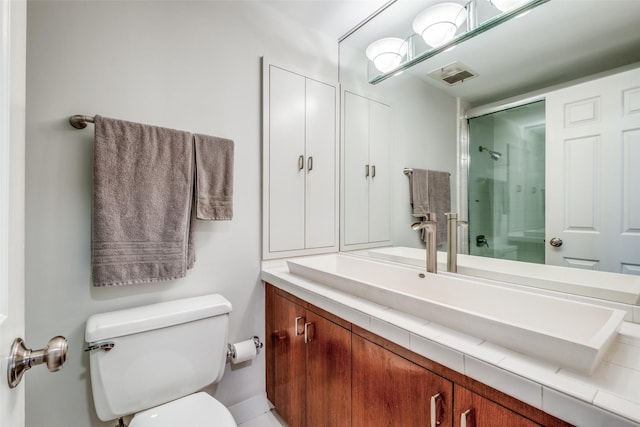 full bathroom with toilet, visible vents, an enclosed shower, and vanity