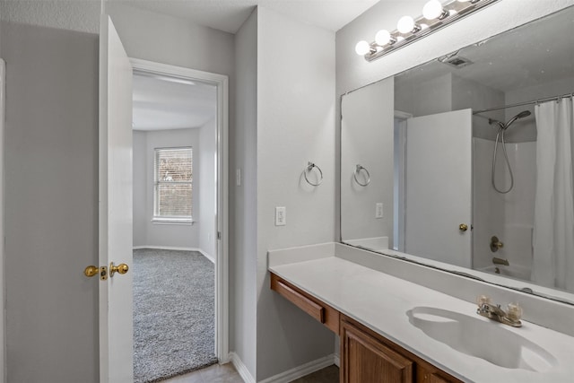 full bathroom with visible vents, baseboards, vanity, and shower / tub combo with curtain