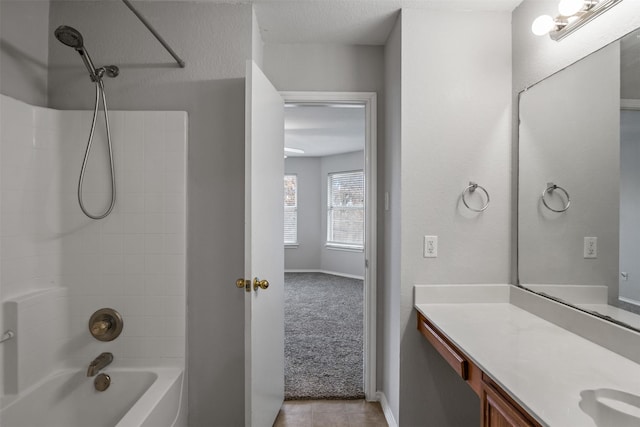 bathroom with shower / bathing tub combination, vanity, baseboards, and a textured ceiling