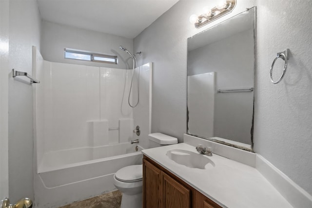 bathroom featuring a textured wall, shower / tub combination, vanity, and toilet