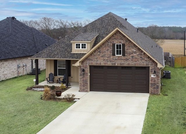 traditional-style house with central AC, brick siding, driveway, roof with shingles, and a front yard