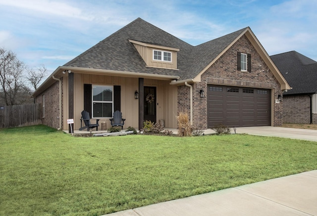 view of front of house with roof with shingles, a front yard, concrete driveway, and brick siding