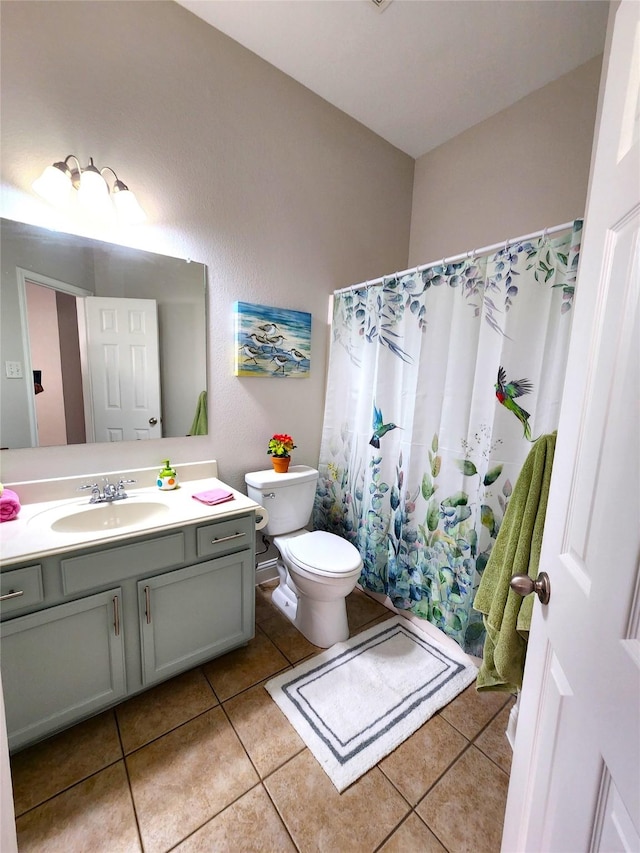 full bath featuring tile patterned flooring, vanity, and toilet