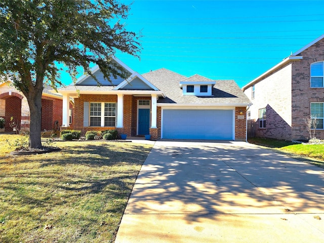 view of front of home with a garage, brick siding, a shingled roof, driveway, and a front yard