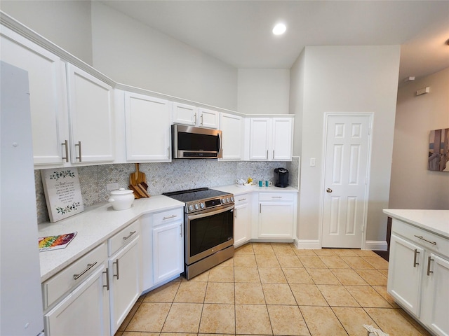 kitchen with stainless steel appliances, white cabinets, light countertops, and tasteful backsplash