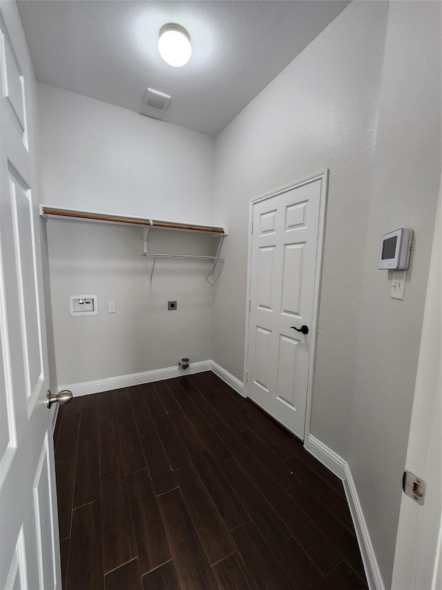 clothes washing area with laundry area, baseboards, dark wood finished floors, and electric dryer hookup