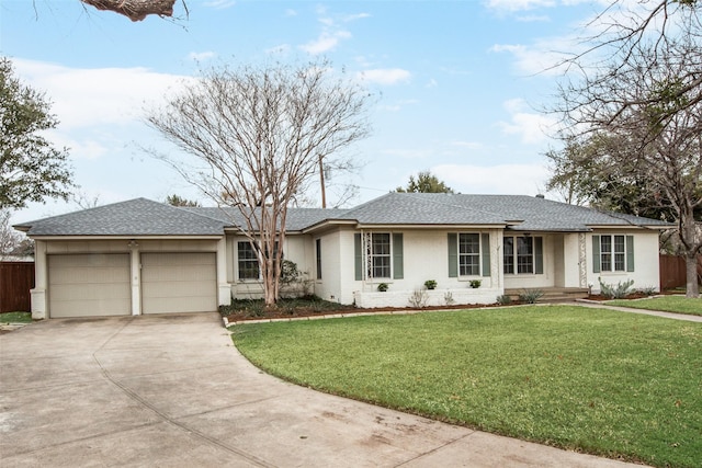 ranch-style house featuring an attached garage, concrete driveway, a shingled roof, and a front yard