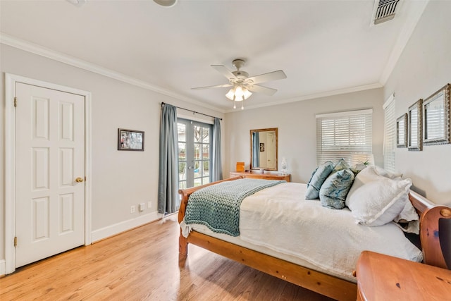 bedroom with visible vents, light wood-style flooring, and multiple windows