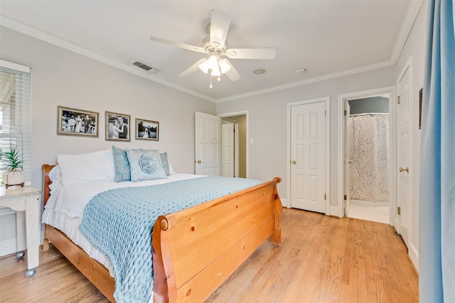 bedroom featuring light wood-type flooring, visible vents, and ornamental molding