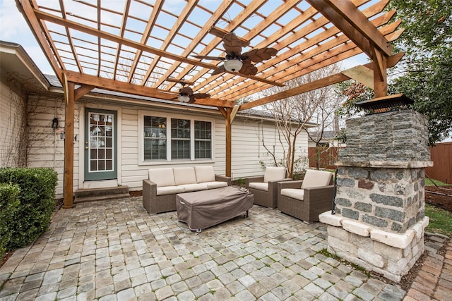 view of patio with an outdoor living space with a fireplace, fence, ceiling fan, and a pergola