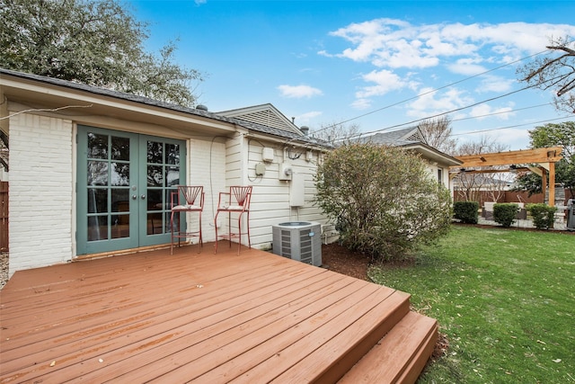 wooden deck featuring french doors, a lawn, and central AC unit