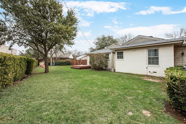 view of yard with fence and a deck