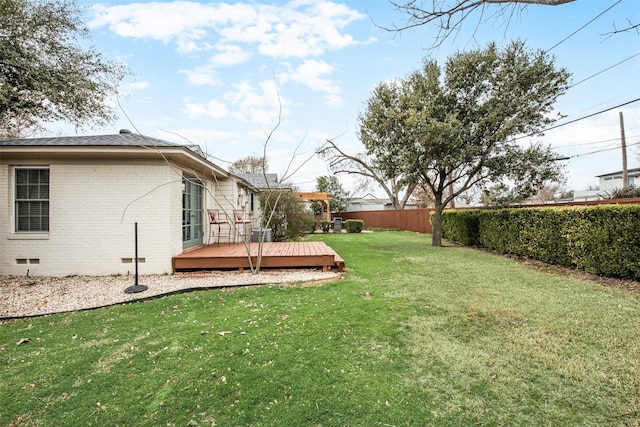 view of yard featuring fence and a wooden deck