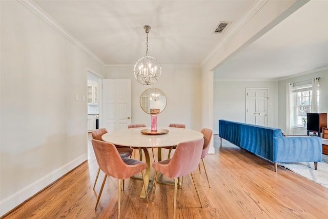 dining room with light wood-style floors, visible vents, a notable chandelier, and ornamental molding