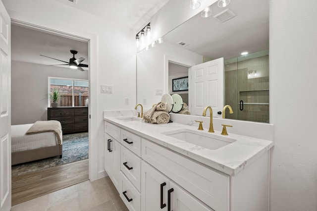 ensuite bathroom with a sink, ceiling fan, double vanity, and connected bathroom