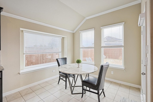 dining space featuring vaulted ceiling, baseboards, and crown molding