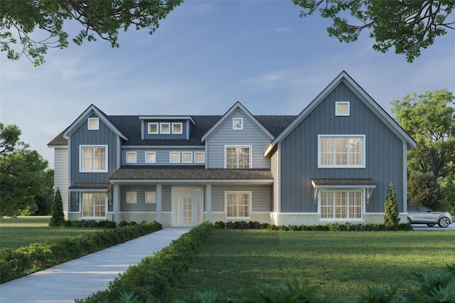 view of front facade featuring french doors, a shingled roof, board and batten siding, a front yard, and stone siding