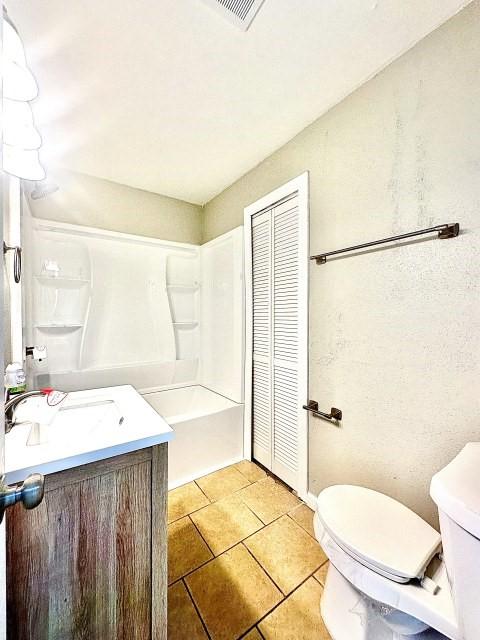 bathroom featuring a closet, vanity, and toilet