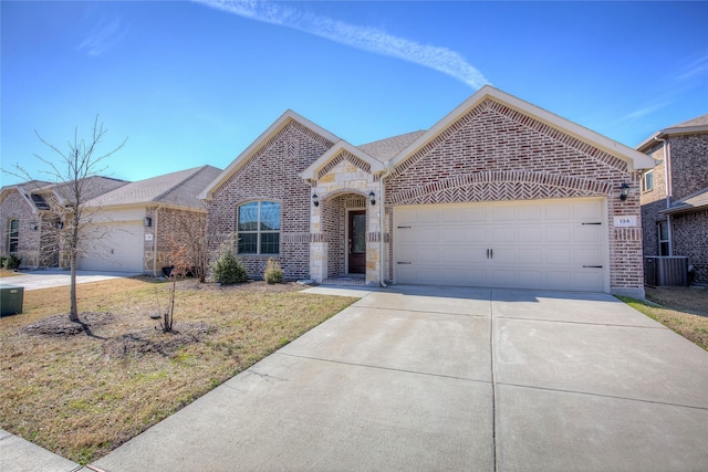 view of front of house with a garage, driveway, central AC unit, and brick siding