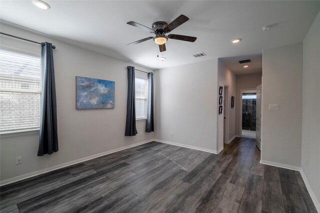 spare room featuring baseboards, visible vents, dark wood-type flooring, and recessed lighting