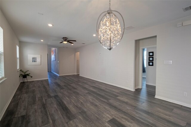 unfurnished living room featuring baseboards, dark wood-type flooring, visible vents, and recessed lighting