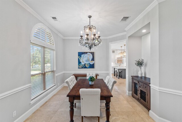 entrance foyer with baseboards, stairway, an inviting chandelier, and crown molding