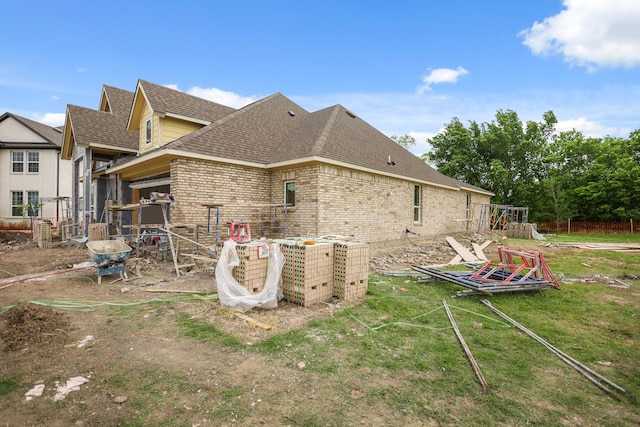 6306 Marlbourough Ct, Garland, TX 75043 - back of property featuring a shingled roof, brick siding, and a yard